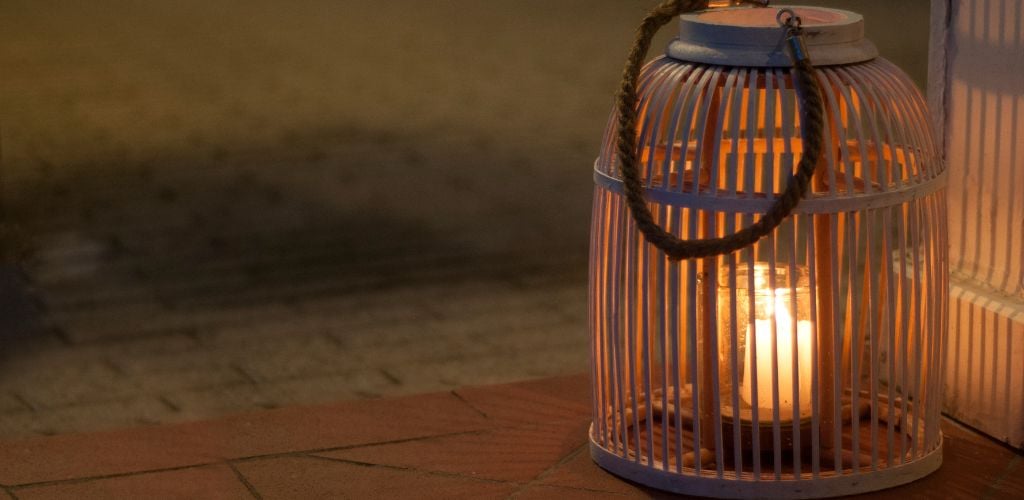 Wood and glass candle lanterns illuminates the way during a ghost tour
