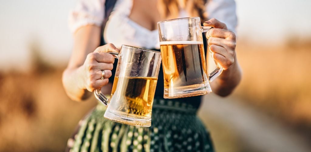 A woman holding a beer for Oktoberfest 