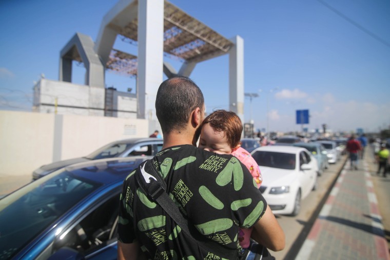 People wait in Gaza for the opening of the Rafah border crossing with Egypt.