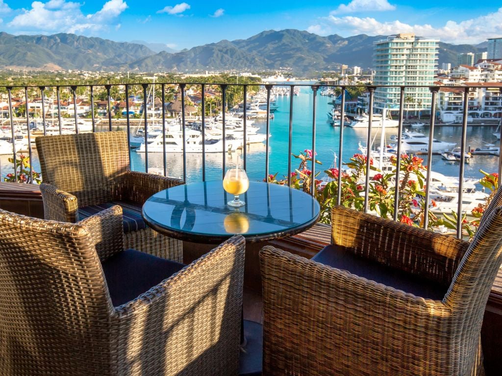 view from a condominium at the marina of the mountains and boats in puerto vallarta