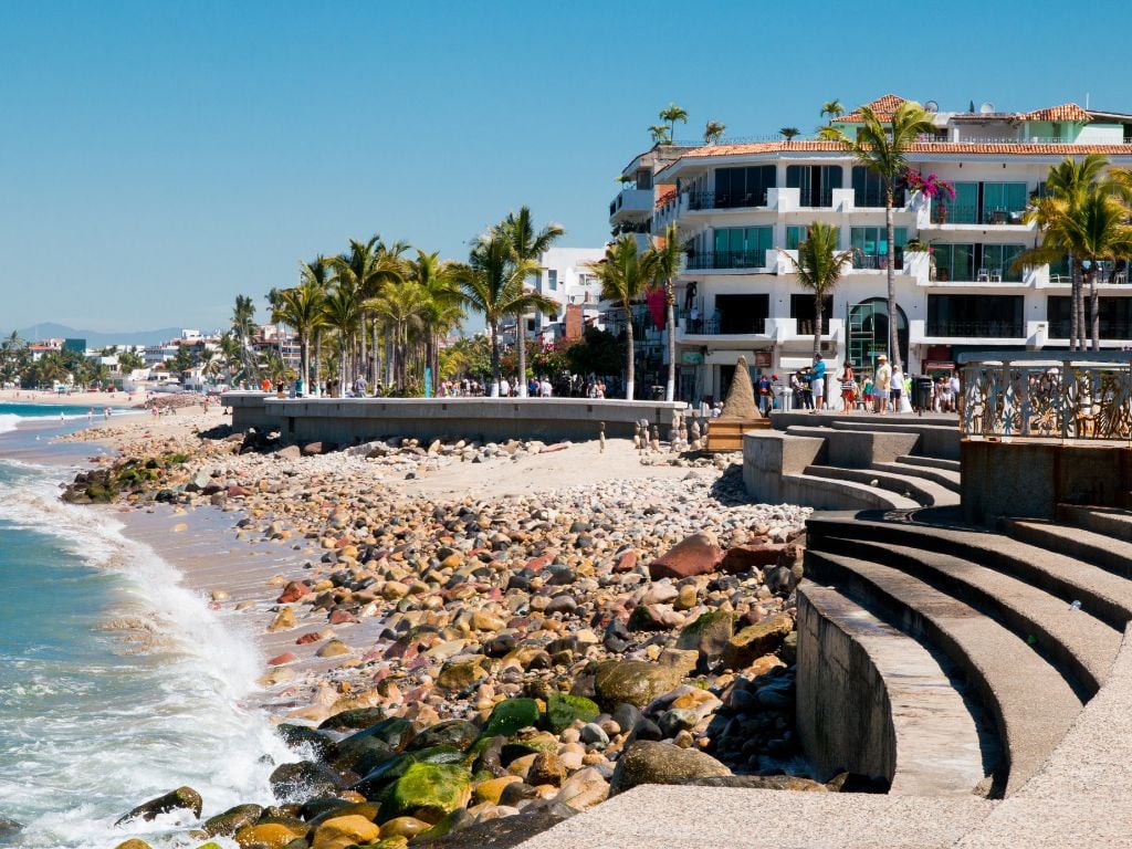 the malecon in puerto vallarta with rocks, an amphitheatre and palm trees