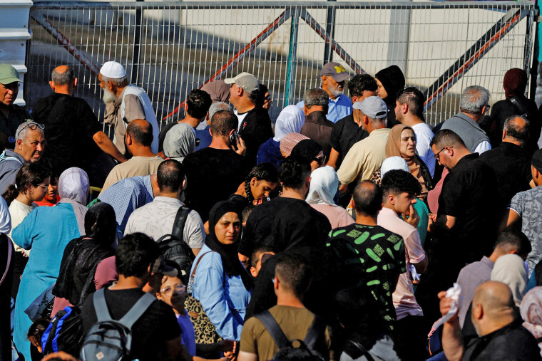 Palestinians with dual citizenship gather outside Rafah border crossing with Egypt