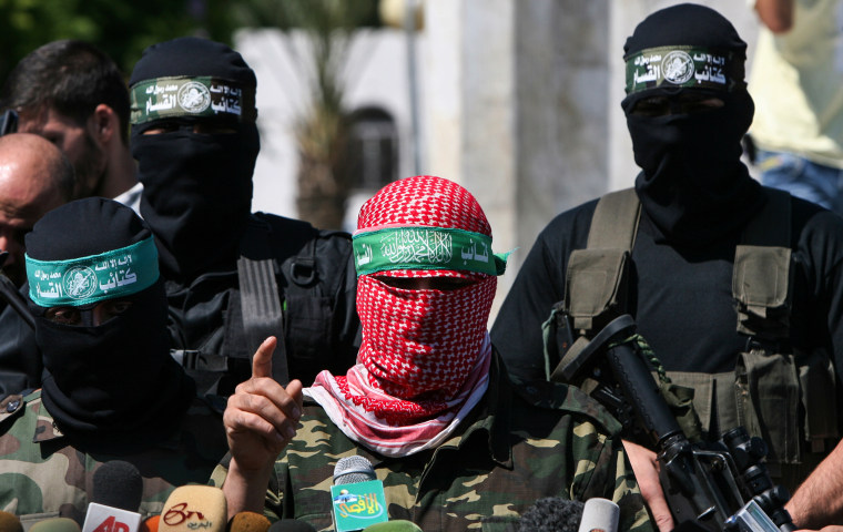 Abu Obaida, center, spokesman for the Al-Qassam Brigades, the armed wing of Hamas, in Gaza City.