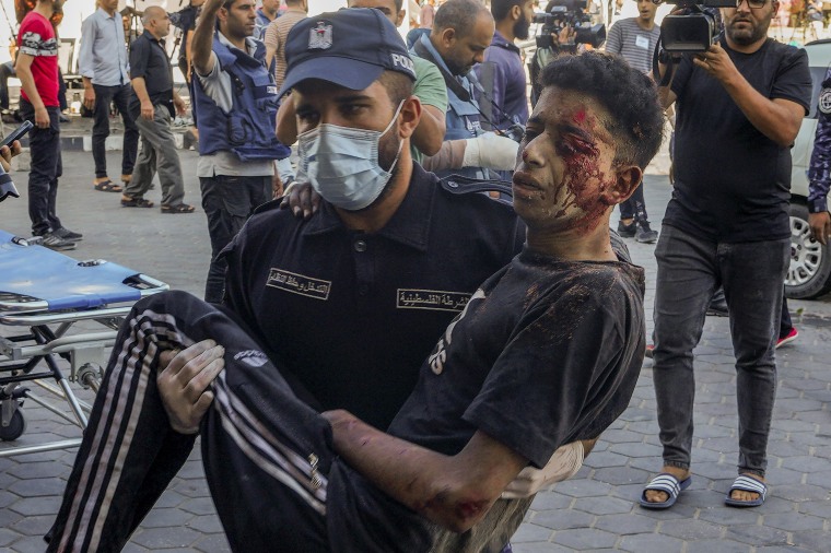 A wounded man is rushed into al-Aqsa hospital in Deir el-Balah, Gaza, on Oct. 15, 2023.