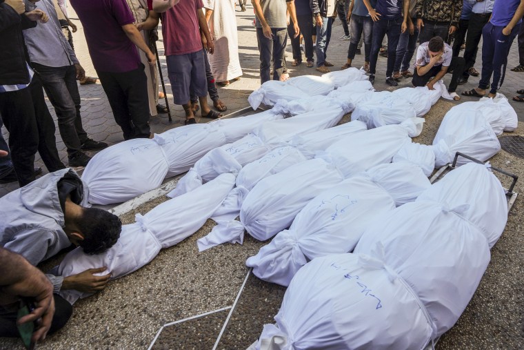 Outside al-Aqsa hospital in Deir el-Balah, Gaza, people mourn those killed during an Israeli airstrike.