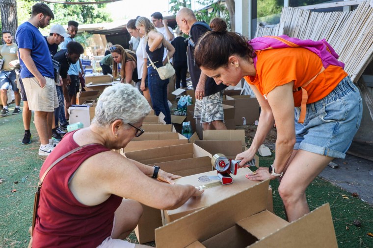 Volunteers pack boxes for soldiers and evacuated people in Tel Aviv on Oct. 12, 2023.