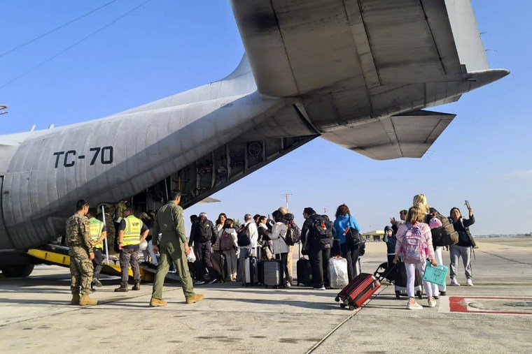 Argentine citizens boarding an Argentine Air Force C-130 Hercules aircraft at Ben Gurion International Airport in Tel Aviv.
