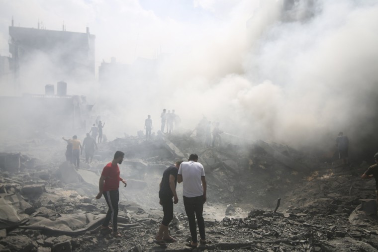 Palestinians look for survivors after an Israeli airstrike in Rafah refugee camp in Gaza.