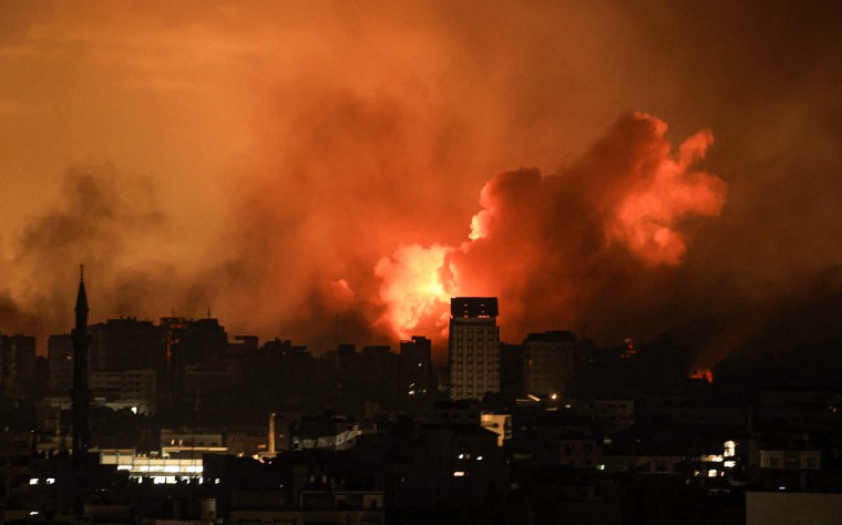 A ball of fire erupts in Gaza City after an Israeli airstrike.