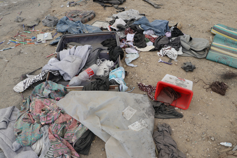 A suitcase lies open with personal items, including clothing, a razor and markers, scattered around at the festival grounds near Re'im where at least 260 people were killed and others were taken hostage by Hamas militants on Oct. 7.