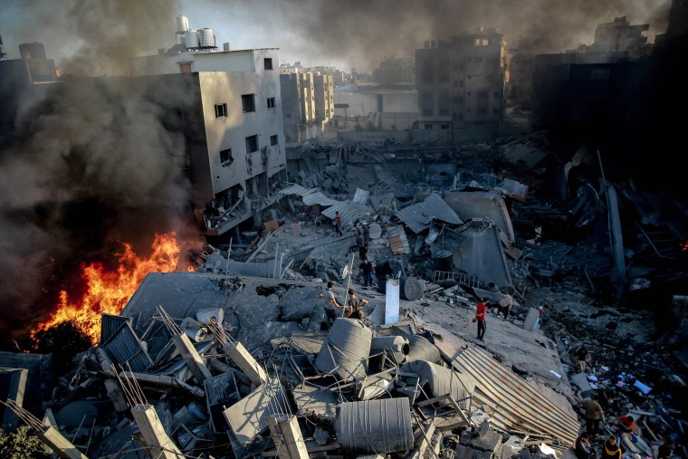 Smoke and fire rise from a levelled building in Gaza City on Oct. 26, 2023.
