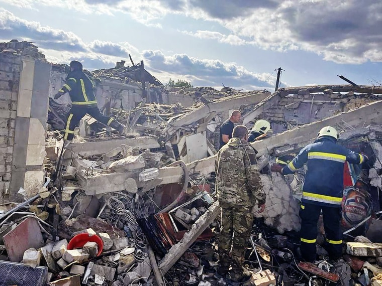 Emergency workers search the victims of a Russian rocket attack in Hroza, near Kharkiv, Ukraine, on Oct. 5, 2023. 