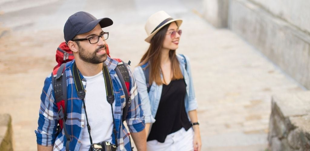 Young couple of backpacker tourist walking together. 