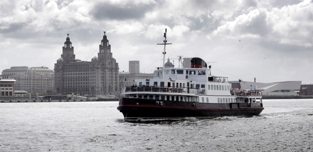 A cruise in River Mersey and a historic structures and building in the background. 