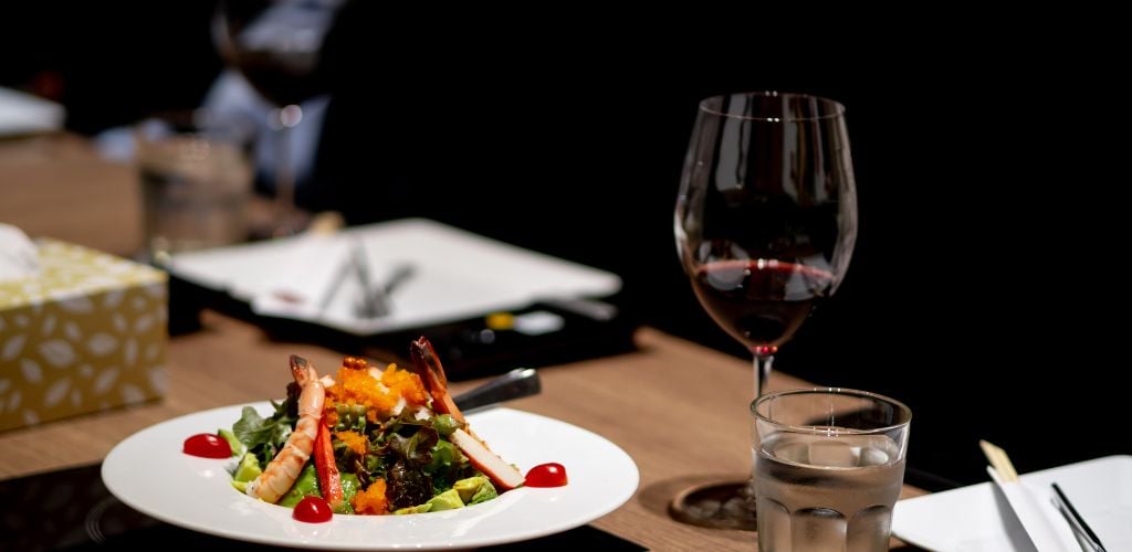 Dinner is placed on the dining table in a fine dining restaurant