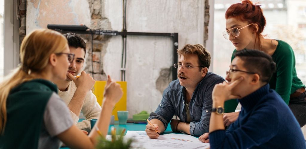 group of friends working together in a co working space