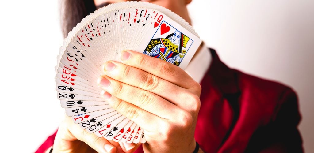 Magician Doing Tricks with a Deck of Cards.