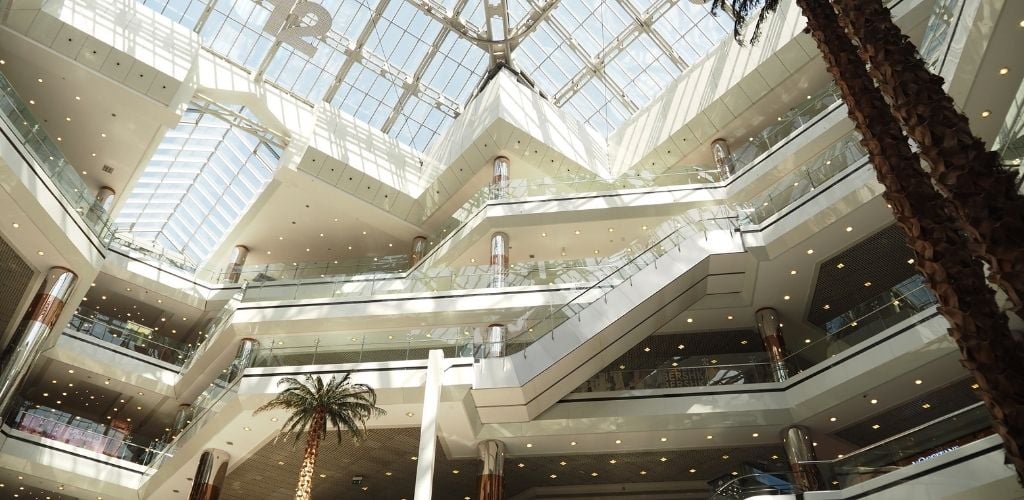 Inside of the mall, viewing a stair and transparent roof. 