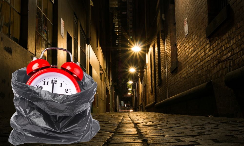 A spooky alarm clock in a dark alley