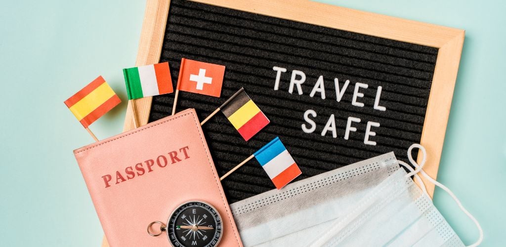 Travel safely concept. Essential travel accessories: passports, medical masks.