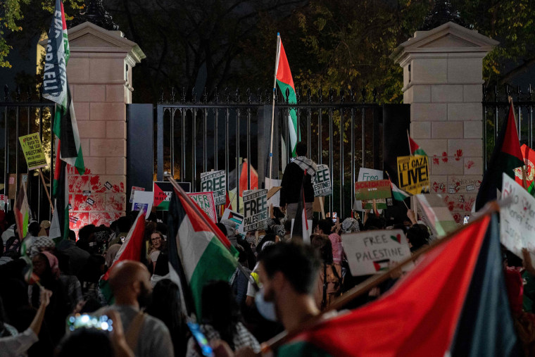 Demonstrators leave red hand prints on the fence in front of the White House during a rally in Washington in support of Palestinians on Nov. 4, 2023.