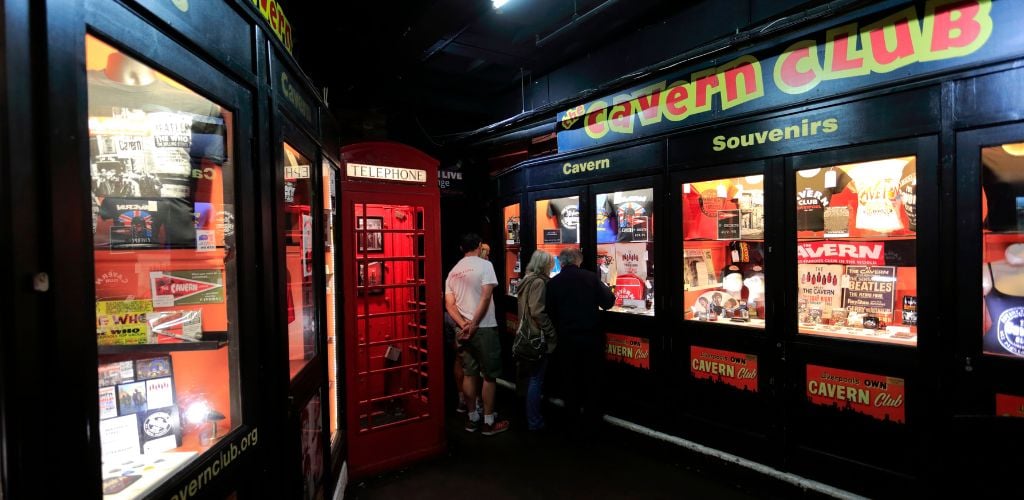 Inside the Cavern Club, there is a red old telephone booth and other Beatles souvenirs.