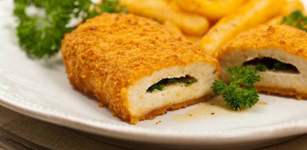 Chicken Kiev cutlet. Boneless chicken breast with butter and herbs. Selective focus. 