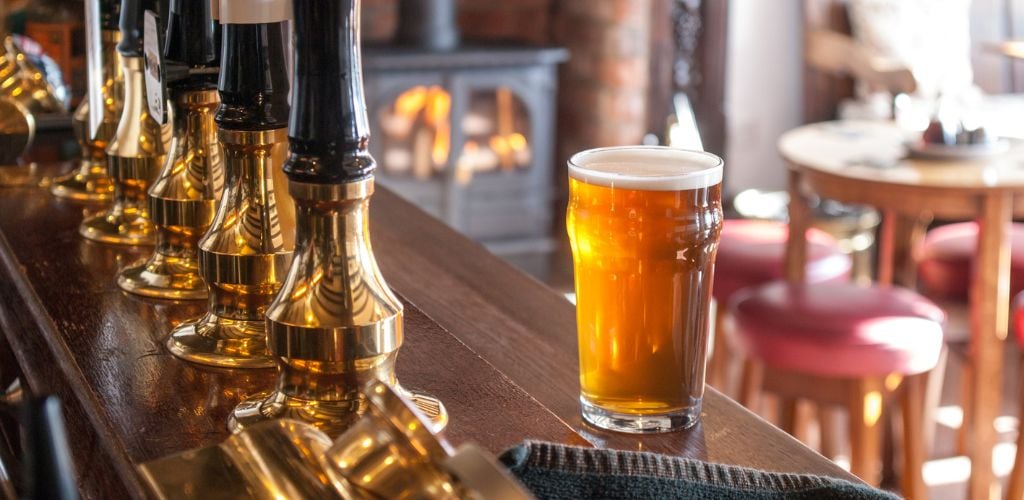 A glass of beer at the Pub counter on a beautiful day. 