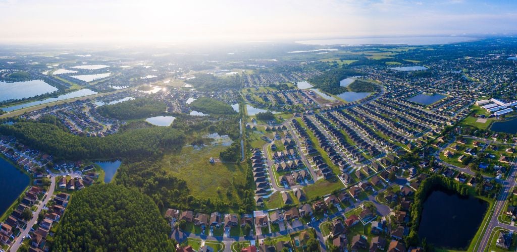 Kissimmee Florida aerial view. Houses and mini lakes around the city and green land. 