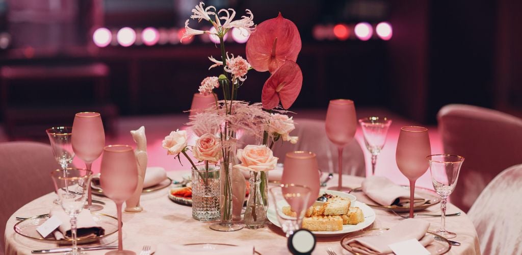 Romantic Dinner Pink Decor Table with pink flowers at Restaurant