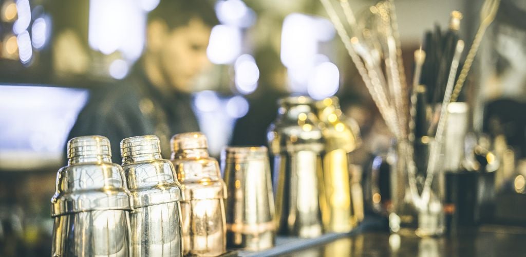 Blurred Defocused View of Barman Preparing Drinks at Speakeasy 