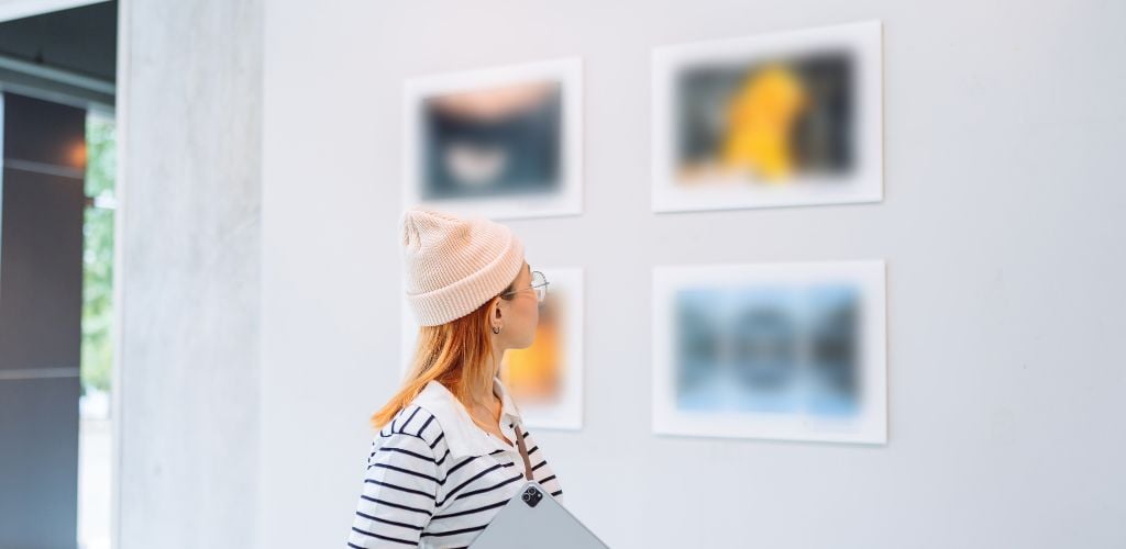 Woman looking photo in art gallery. 