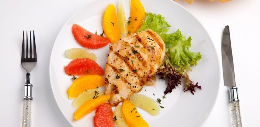 Grilled chicken breast with citrus salad- pink grapefruit, lime, orange, lettuce and fresh thyme. 