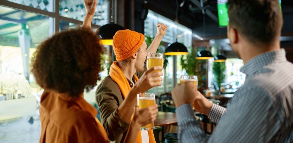 Friends Fans Watch Sport Tv in Pub and Cheering Together