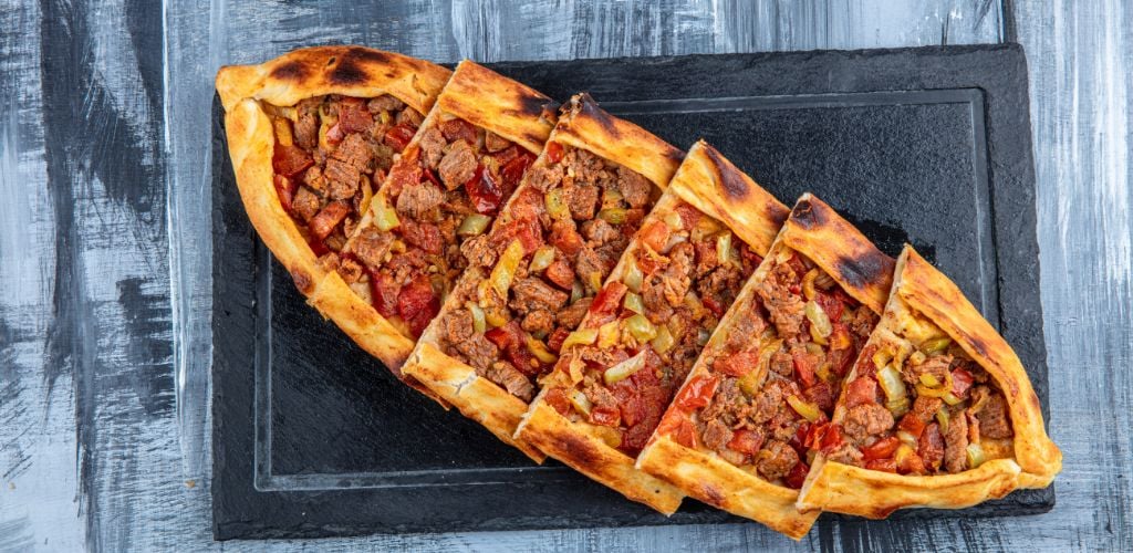 Traditional Turkish Cuisine; pide with cubed meat / kusbasili pide.Turkish pita concept.