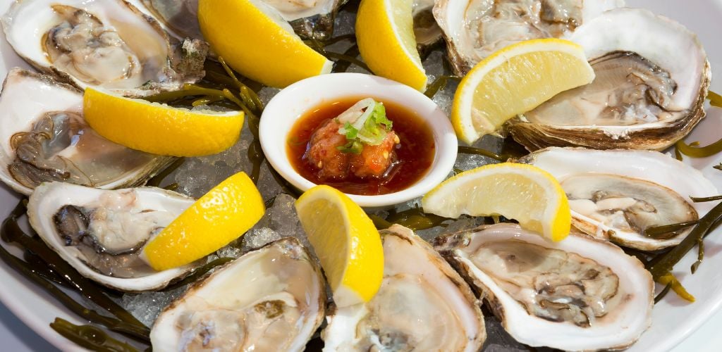 Oysters in ice with lemon, and hot sauce. 