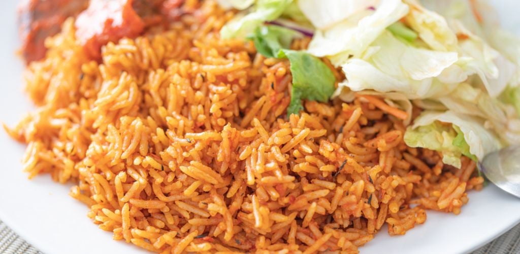 Nigerian African Jellof Rice Served with Vegetable Salad