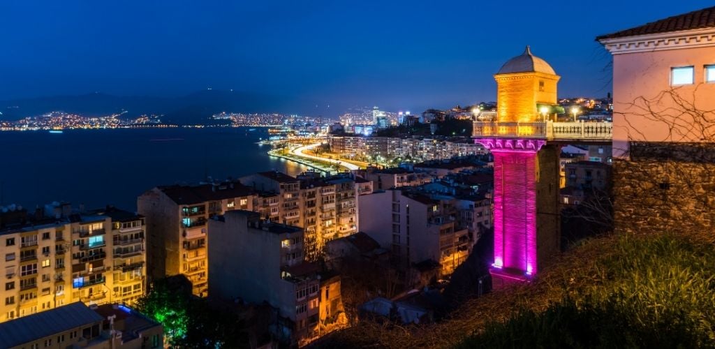 Beautiful night view of Izmir with Historical Elevator, sea, and buildings.