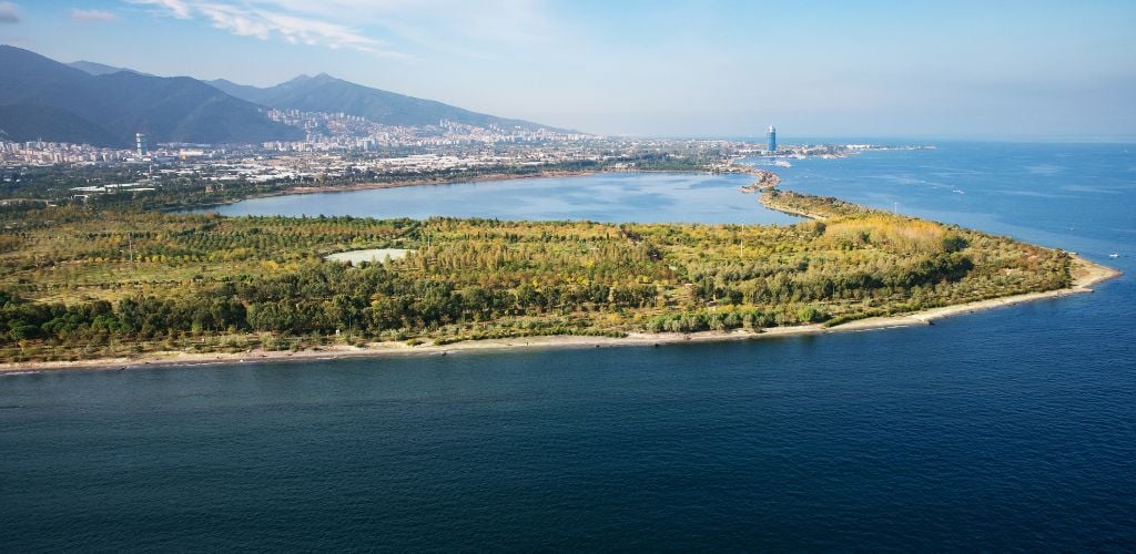 Inciralti City Forest Aerial view, green island, mountains, and surrounded by sea.