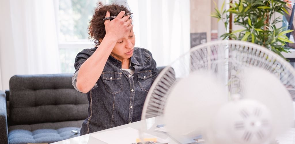 Woman working and suffering for summer hot weather