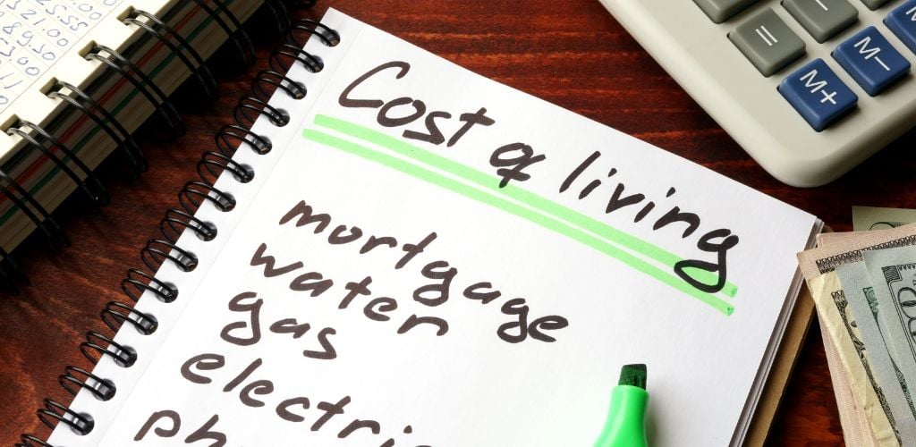 Cost of living written in a notebook and calculations of home finances. 