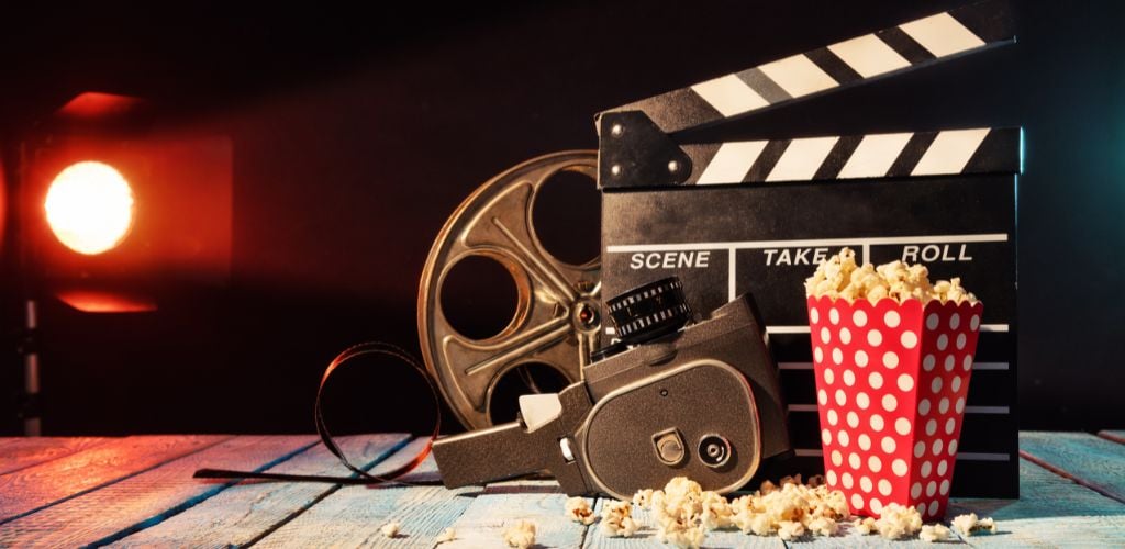 Retro film production accessories placed on wooden planks. 