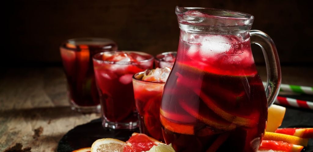 Sangria in pitcher with slices of fruit and ice