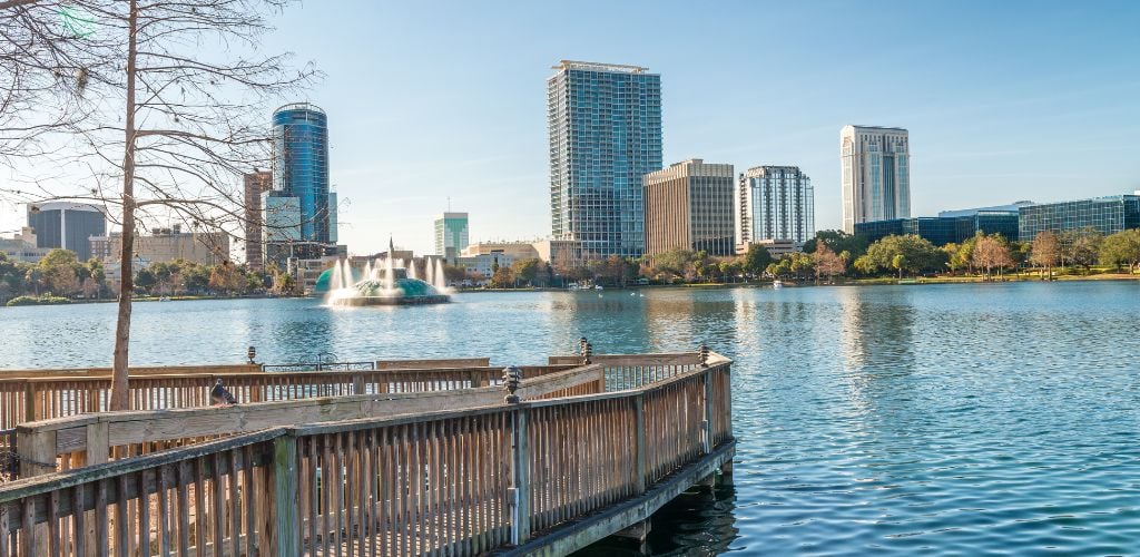 Orlando's Lake Eola, fountain, wood pathway, and buildings.