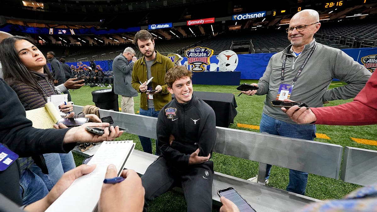 Arch Manning talks to reporters