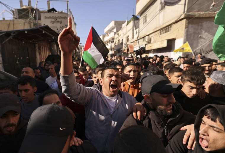 Mourners attend the funeral procession of two men killed in an Israeli army incursion in the al-Fawwar refugee camp, south of Hebron in the occupied West Bank, on Dec. 26, 2023.