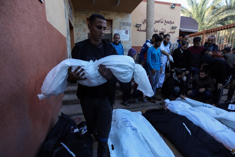 Mourners collect the bodies of loved ones killed in an airstrike on Dec. 26, 2023 in Khan Yunis, Gaza. 