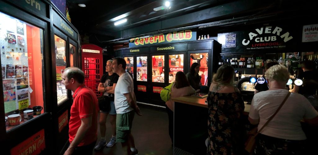 Inside the Cavern Club on Mathew Street. A tourist walking around and standing enjoying the museum 