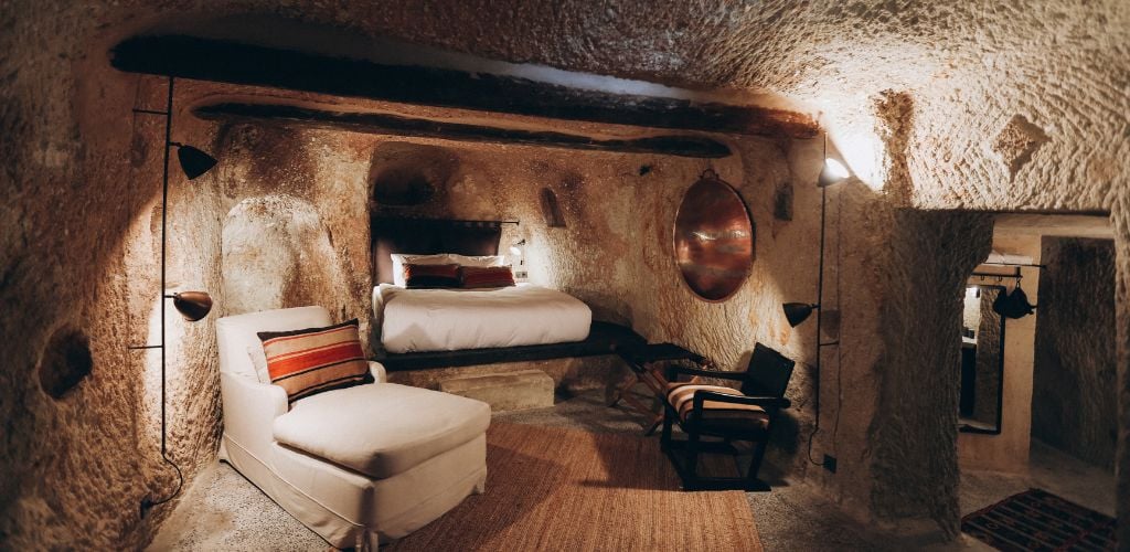 It is a cave hotel with one double bed, a chair, and a few spotlights for the light room. 