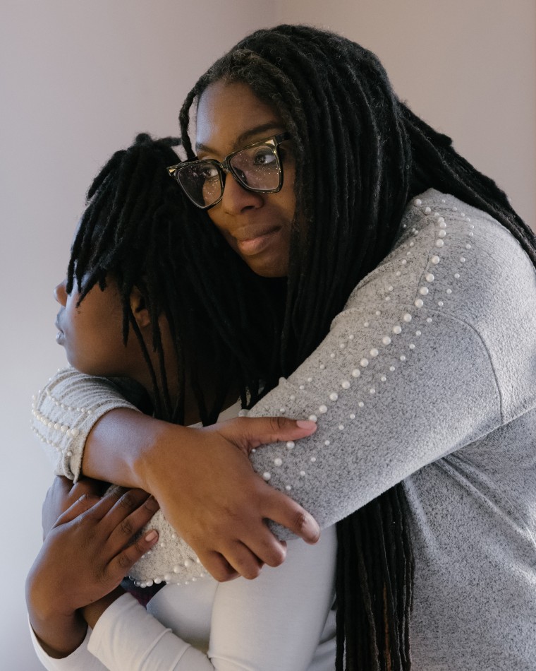 Benton holds her daughter in their home on Dec. 16.